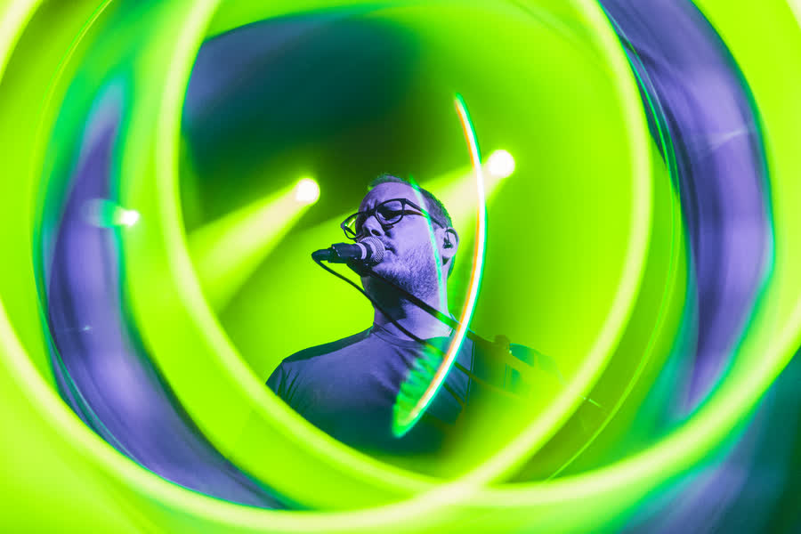 Vocals inside a swirl of green light